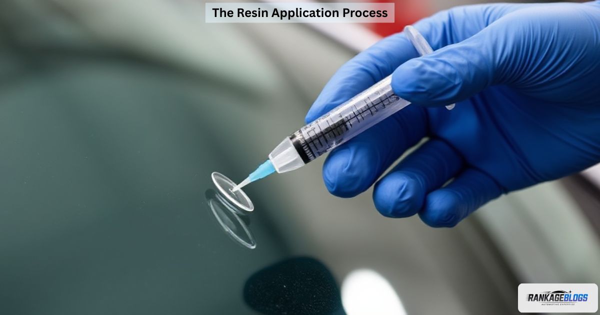 Applying repair resin into a windshield chip using DIY syringe tool.