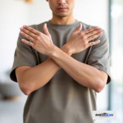 Serious man crossing arms demonstrating refusal of professional auto glass repair advice.